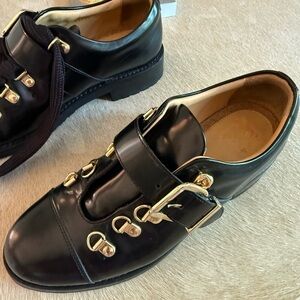 The office of Angela Scott Black Leather Shoes with Gold Accents